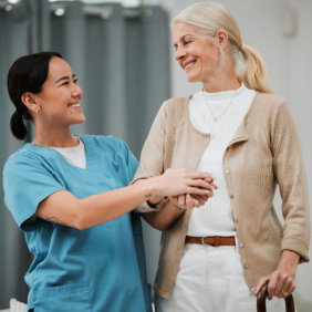 Female nurse assists elderly patient