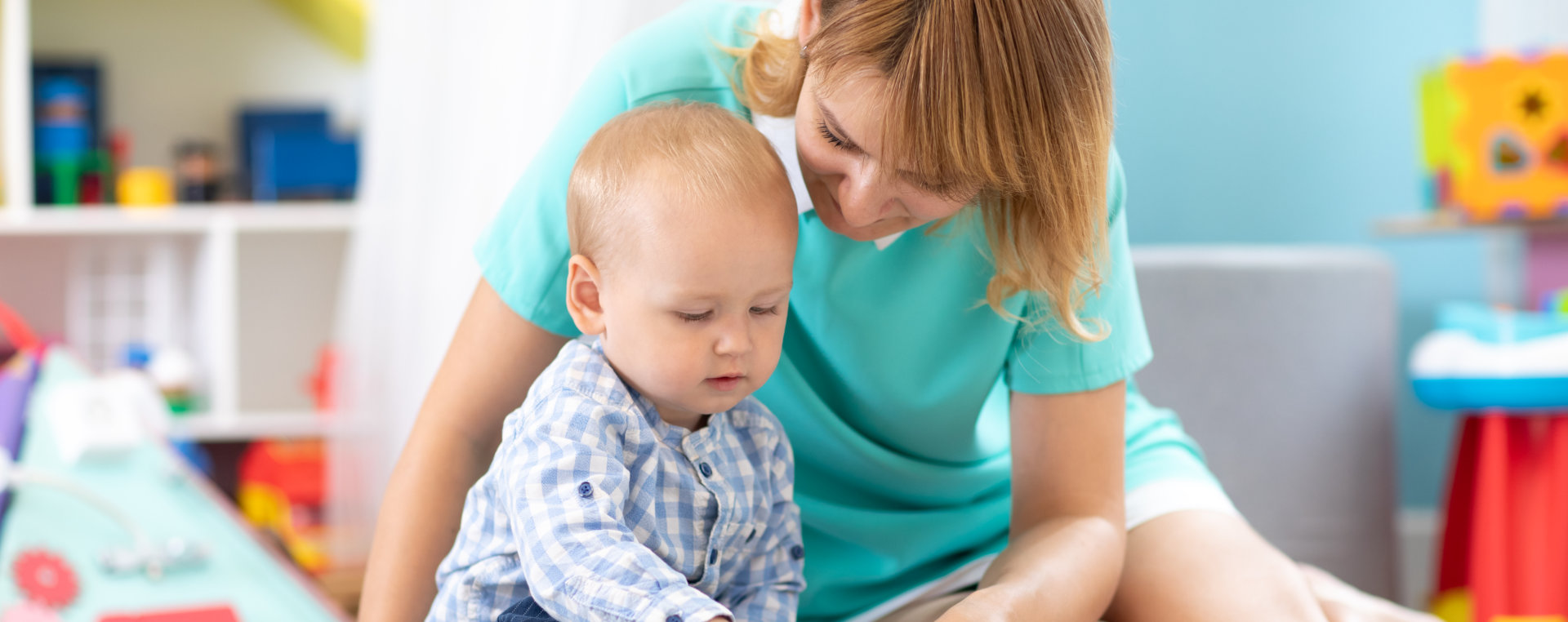 A woman and a baby happily playing with toys, creating joyful moments together